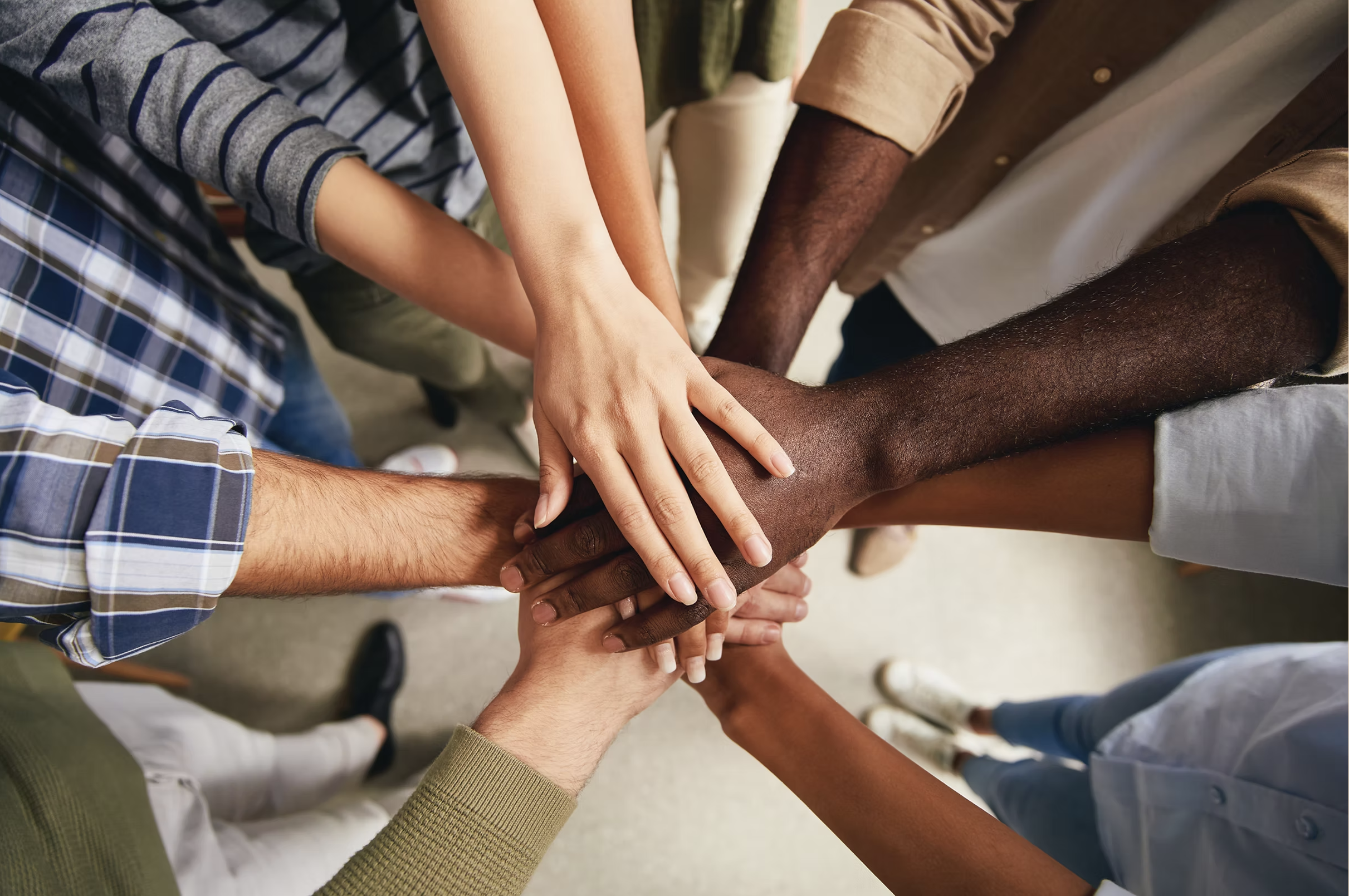 Group with hands together in unity.